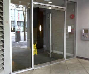Entry glass doors supply and installation for hi rise apartment building Vancouver downtown.